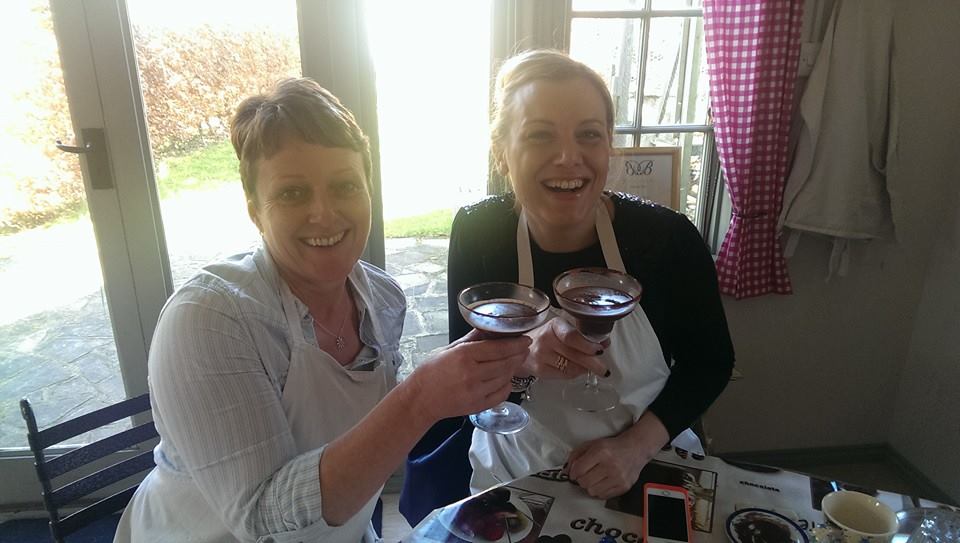 Two ladies sitting with chocolate cocktails at the table