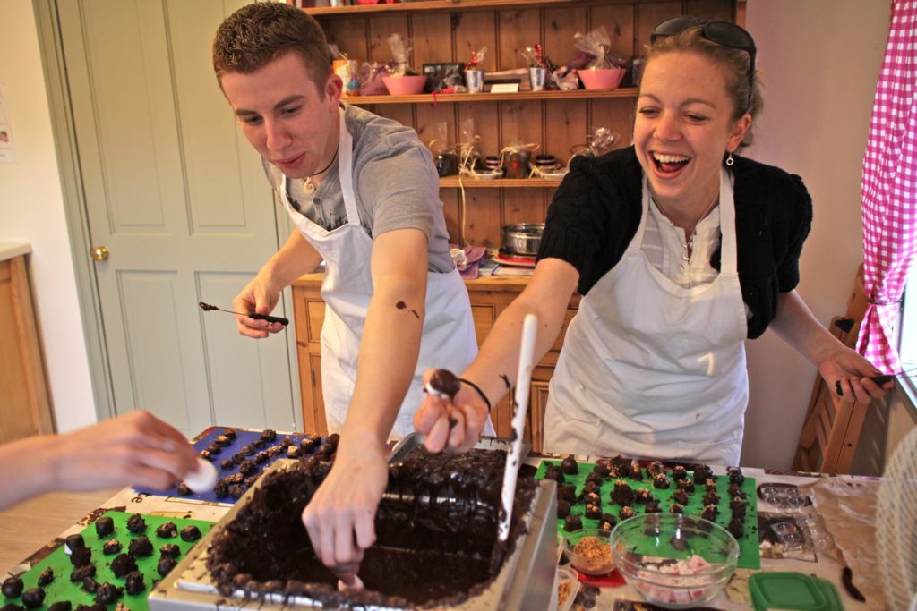 Two people making chocolates