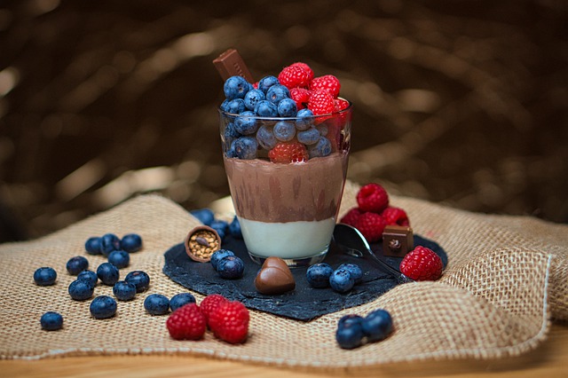 Chocolate pudding in a glass with blueberries and raspberries