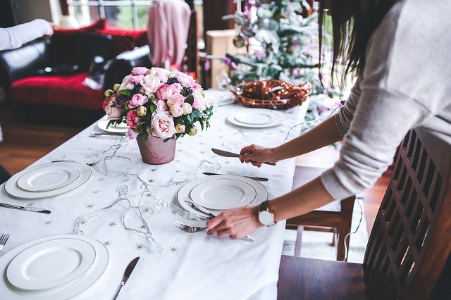 Lady laying dinner table