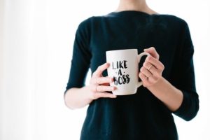 Lady holding a mug that says like a boss