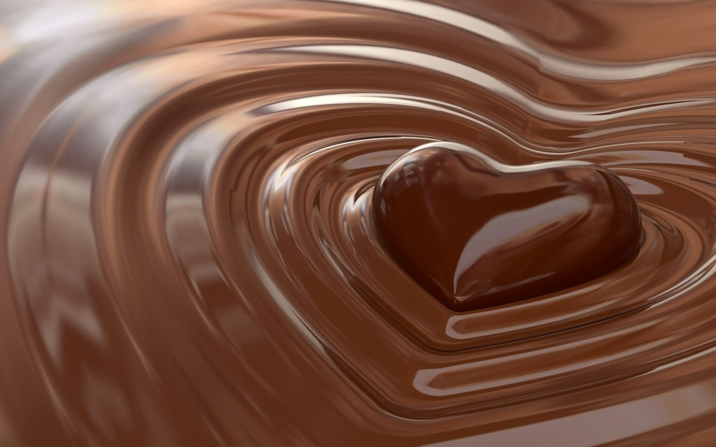 chocolate heart in melting chocolate puddle