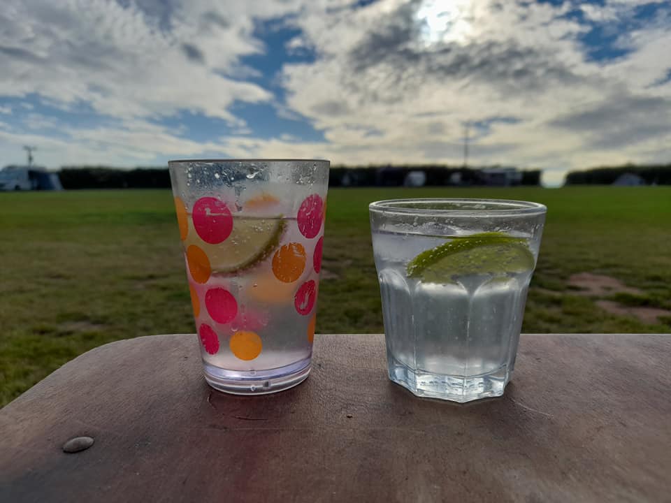 Two glasses on a table with a view of the sky