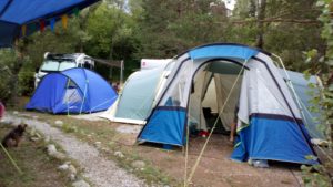 Two tents, one small, one large with awning.