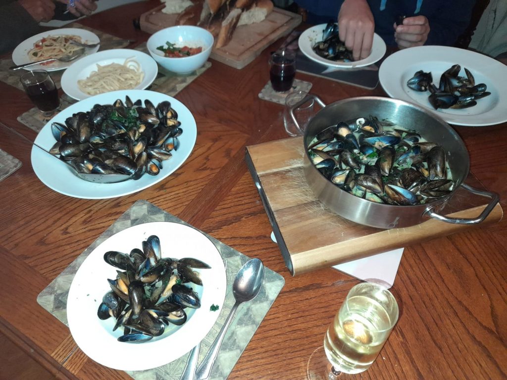 Dishes and plates of mussels on the table