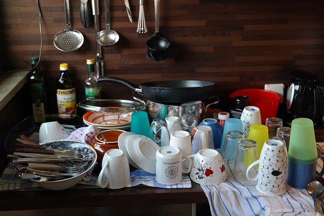 A pile of recently washed up dishes and other kitchen utensils 