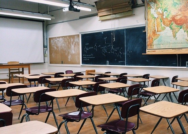 Empty classroom with desks and a blackboard
