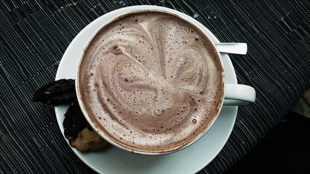 Hot chocolate drink in white cup and saucer