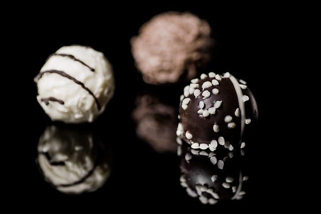 three truffles with different chocolate finishes