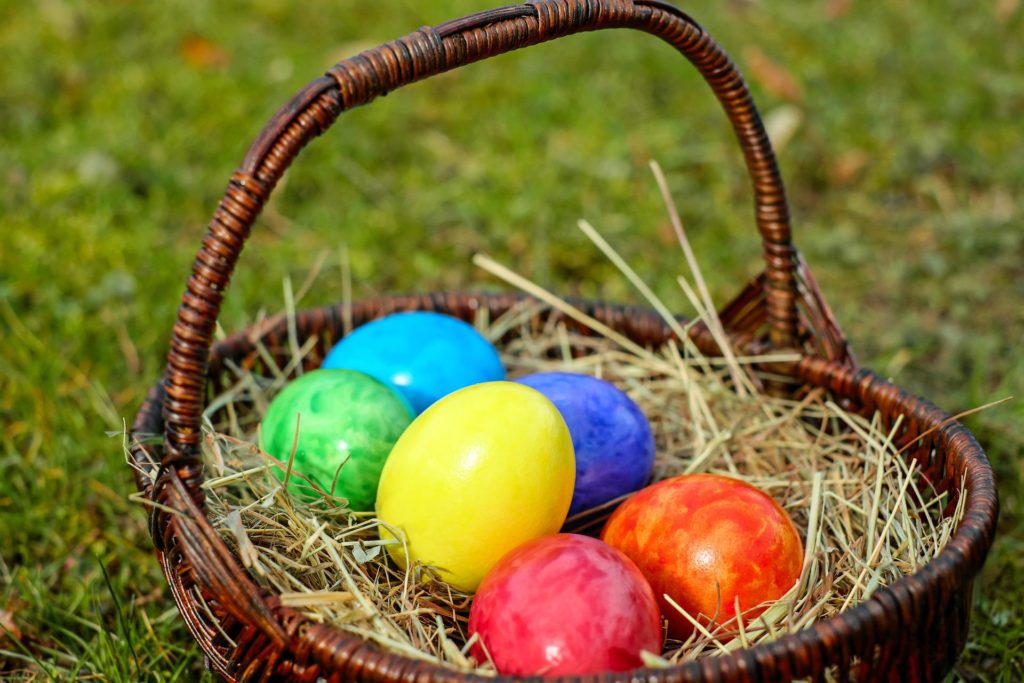Colourful eggs and a basket on the grass
