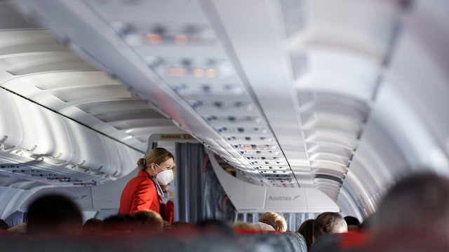 Air hostess in a cabin wearing a mask