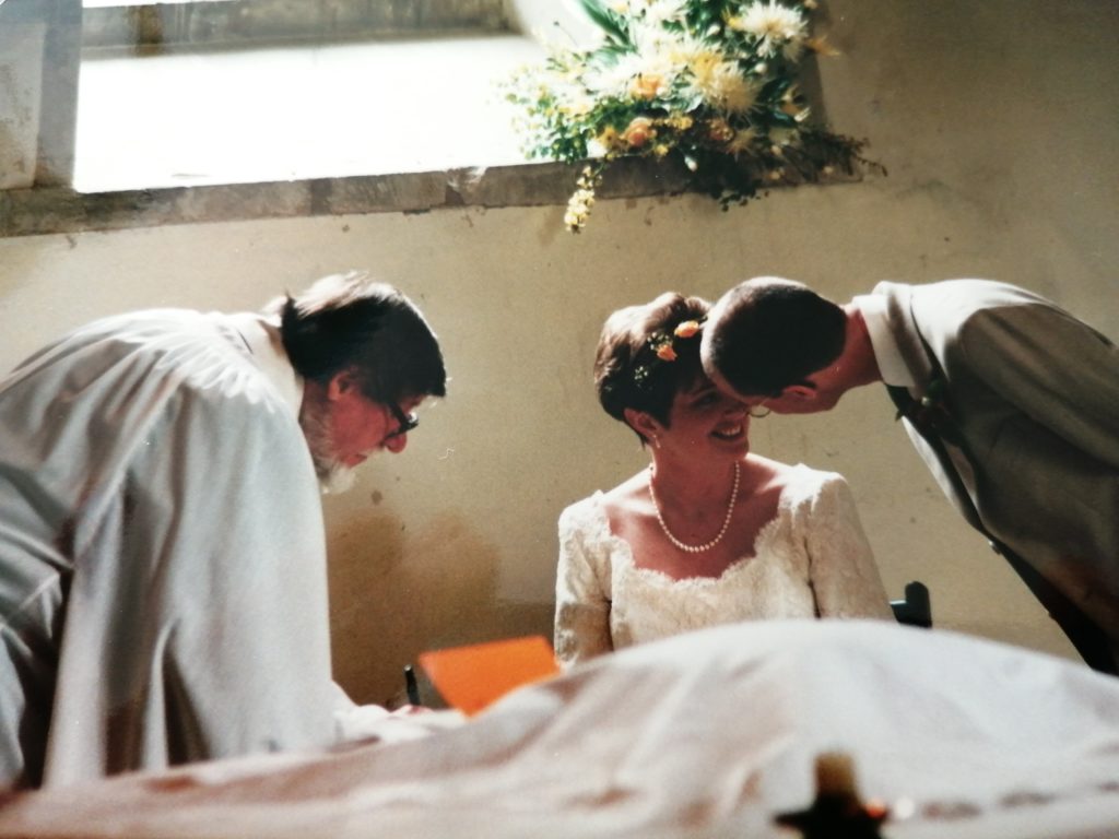 Dawn and Jo Fry at the church with the vicar on their wedding day