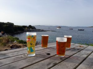 4 pints of beer on a table with a view of the sea at The Turks Head, St Agnes
